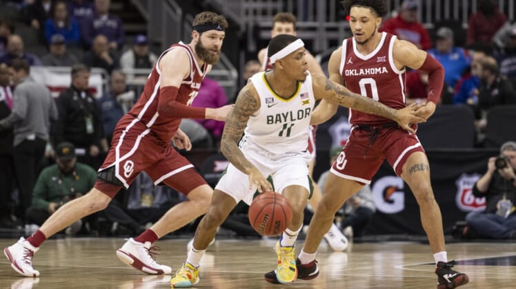 Mar 10, 2022; Kansas City, MO, USA; Baylor Bears guard James Akinjo (11) handles the ball while defended by Oklahoma Sooners guard Jordan Goldwire (0) in the first half at T-Mobile Center. Mandatory Credit: Amy Kontras-USA TODAY Sports
