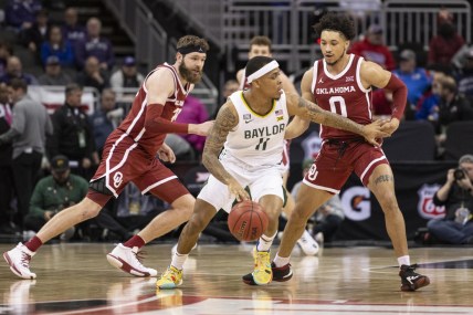 Mar 10, 2022; Kansas City, MO, USA; Baylor Bears guard James Akinjo (11) handles the ball while defended by Oklahoma Sooners guard Jordan Goldwire (0) in the first half at T-Mobile Center. Mandatory Credit: Amy Kontras-USA TODAY Sports