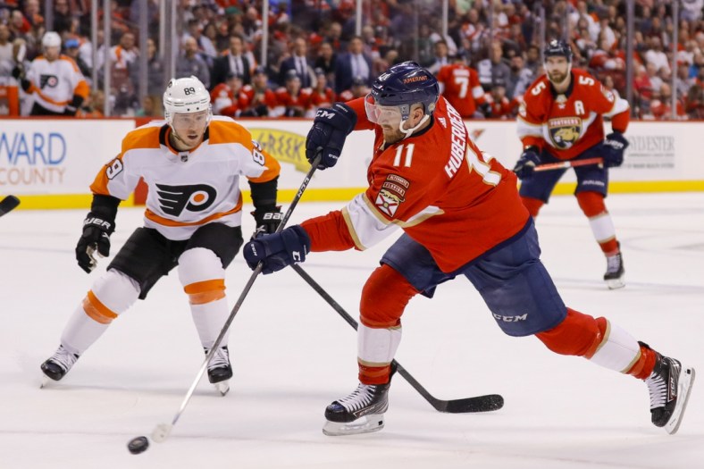 Mar 10, 2022; Sunrise, Florida, USA; Florida Panthers left wing Jonathan Huberdeau (11) shoots the puck during the first period of the game against the Philadelphia Flyers at FLA Live Arena. Mandatory Credit: Sam Navarro-USA TODAY Sports