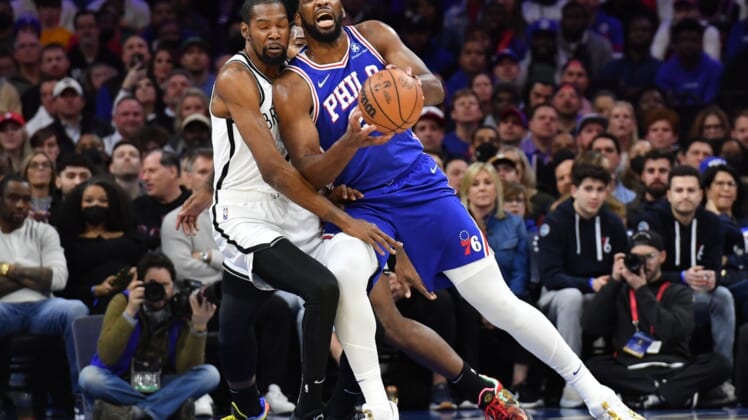Mar 10, 2022; Philadelphia, Pennsylvania, USA; Philadelphia 76ers center Joel Embiid (21) is fouled by Brooklyn Nets forward Kevin Durant (7) during the first quarter at Wells Fargo Center. Mandatory Credit: Eric Hartline-USA TODAY Sports