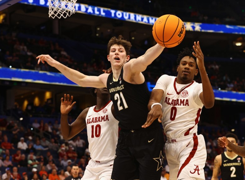 Mar 10, 2022; Tampa, FL, USA; Vanderbilt Commodores center Liam Robbins (21) and Alabama Crimson Tide forward Noah Gurley (0) go after the rebound during the first half at Amalie Arena. Mandatory Credit: Kim Klement-USA TODAY Sports