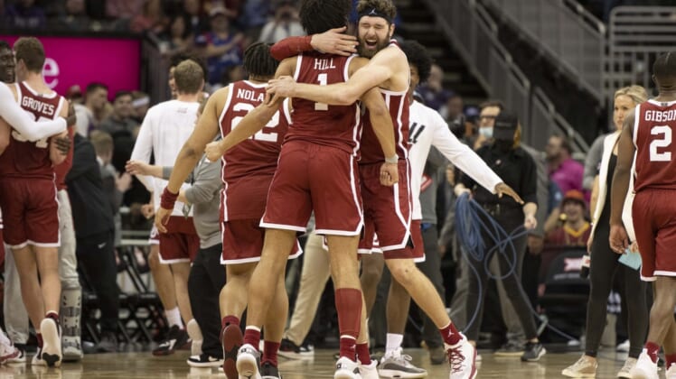 Mar 10, 2022; Kansas City, MO, USA; Oklahoma Sooners center Tanner Groves (35) hugs teammate Oklahoma Sooners forward Jalen Hills (1) after defeating the Baylor Bears at T-Mobile Center. Mandatory Credit: Amy Kontras-USA TODAY Sports
