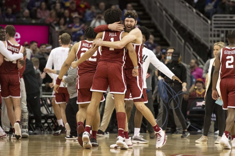 Mar 10, 2022; Kansas City, MO, USA; Oklahoma Sooners center Tanner Groves (35) hugs teammate Oklahoma Sooners forward Jalen Hills (1) after defeating the Baylor Bears at T-Mobile Center. Mandatory Credit: Amy Kontras-USA TODAY Sports
