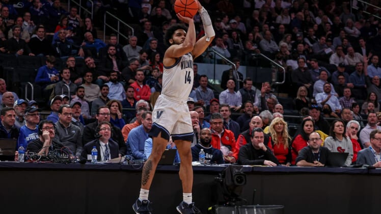 Mar 10, 2022; New York, NY, USA; Villanova Wildcats guard Caleb Daniels (14) makes a three point basket against the St. John's Red Storm during the second half at Madison Square Garden. Mandatory Credit: Vincent Carchietta-USA TODAY Sports