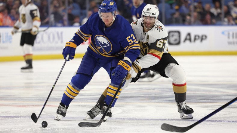 Mar 10, 2022; Buffalo, New York, USA;  Buffalo Sabres left wing Jeff Skinner (53) looks to control the puck as Vegas Golden Knights left wing Max Pacioretty (67) defends during the third period at KeyBank Center. Mandatory Credit: Timothy T. Ludwig-USA TODAY Sports