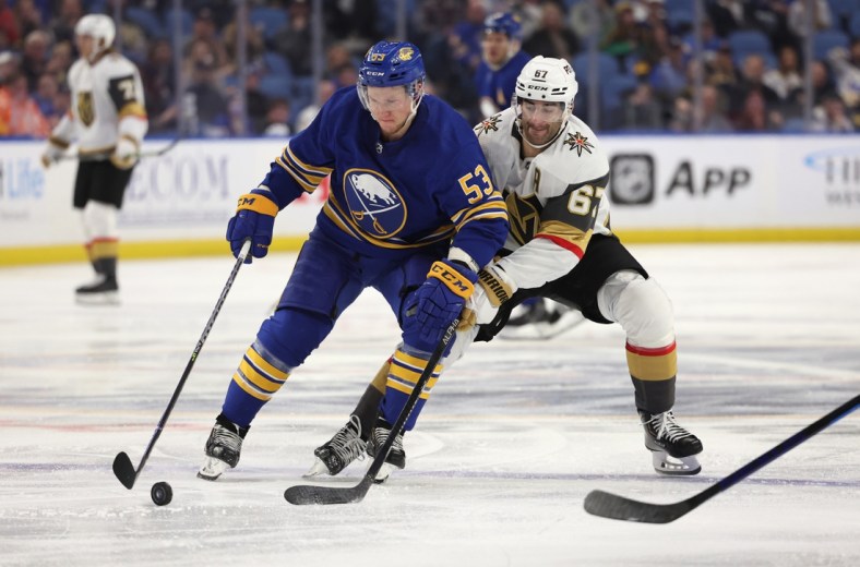 Mar 10, 2022; Buffalo, New York, USA;  Buffalo Sabres left wing Jeff Skinner (53) looks to control the puck as Vegas Golden Knights left wing Max Pacioretty (67) defends during the third period at KeyBank Center. Mandatory Credit: Timothy T. Ludwig-USA TODAY Sports