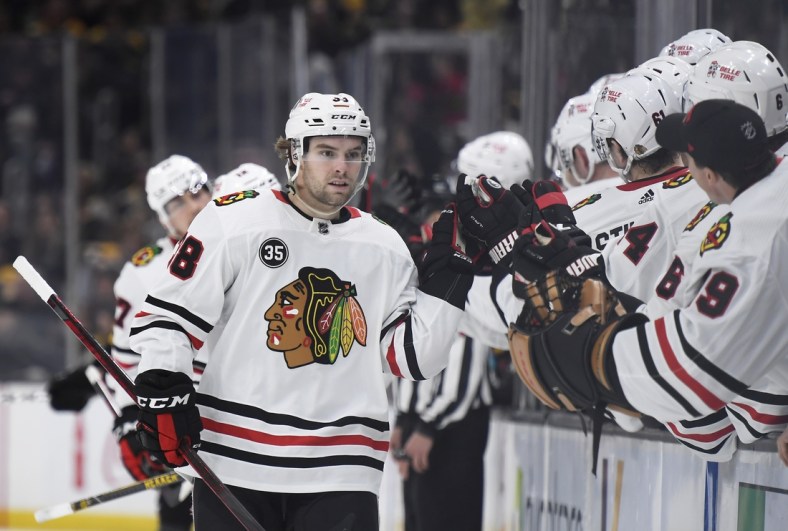 Mar 10, 2022; Boston, Massachusetts, USA; Chicago Blackhawks left wing Brandon Hagel (38) is congratulated by his teammates after scoring a goal during the third period against the Boston Bruins at TD Garden. Mandatory Credit: Bob DeChiara-USA TODAY Sports