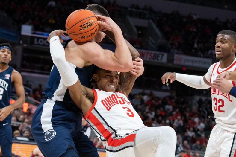 Mar 10, 2022; Indianapolis, IN, USA; Penn State Nittany Lions forward John Harrar (21) and Ohio State Buckeyes guard Eugene Brown III (3) fight for a rebound in the first half at Gainbridge Fieldhouse. Mandatory Credit: Trevor Ruszkowski-USA TODAY Sports