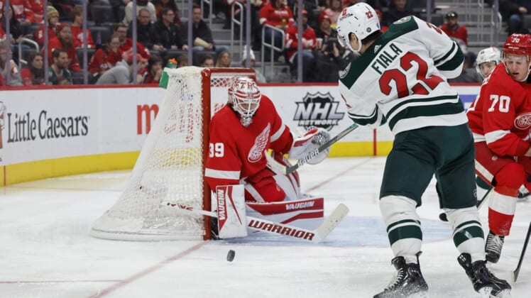 Mar 10, 2022; Detroit, Michigan, USA;  Minnesota Wild left wing Kevin Fiala (22) takes a shot on  Detroit Red Wings goaltender Alex Nedeljkovic (39) in the third period at Little Caesars Arena. Mandatory Credit: Rick Osentoski-USA TODAY Sports