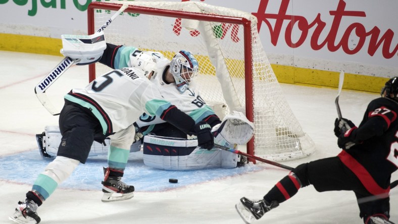 Mar 10, 2022; Ottawa, Ontario, CAN; Seattle Kraken goalie Chris Driedger (60) makes a save on a shot from Ottawa Senators center Dylan Gambrell (27) in the third period at the Canadian Tire Centre. Mandatory Credit: Marc DesRosiers-USA TODAY Sports