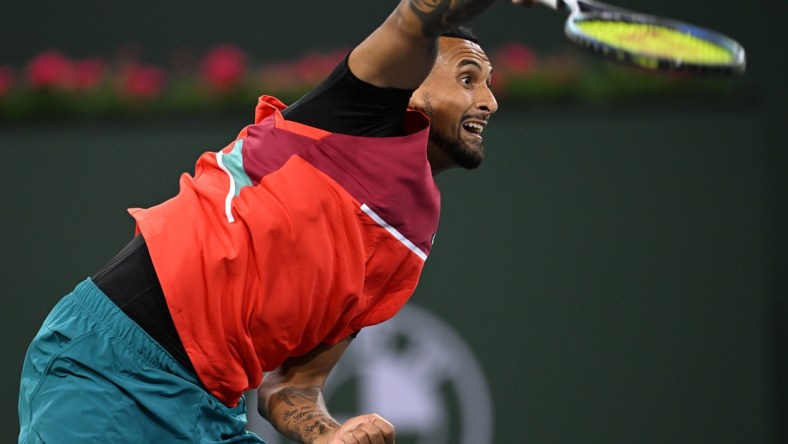 Mar 10, 2022; Indian Wells, CA, USA; Nick Kyrgios (AUS) hits a shot in his first round match against Sebastian Baez (not pictured) on day 4 at the BNP Paribas Open at the Indian Wells Tennis Garden. Mandatory Credit: Jayne Kamin-Oncea-USA TODAY Sports