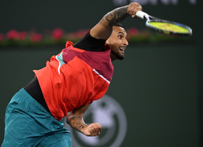 Mar 10, 2022; Indian Wells, CA, USA; Nick Kyrgios (AUS) hits a shot in his first round match against Sebastian Baez (not pictured) on day 4 at the BNP Paribas Open at the Indian Wells Tennis Garden. Mandatory Credit: Jayne Kamin-Oncea-USA TODAY Sports