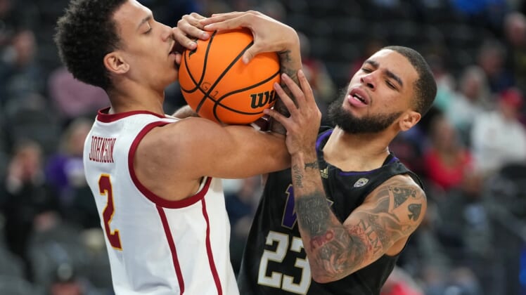 Mar 10, 2022; Las Vegas, NV, USA; USC Trojans forward Kobe Johnson (2) and Washington Huskies guard Terrell Brown Jr. (23) vie for control of the ball after the whistle during the first half at T-Mobile Arena. Mandatory Credit: Stephen R. Sylvanie-USA TODAY Sports