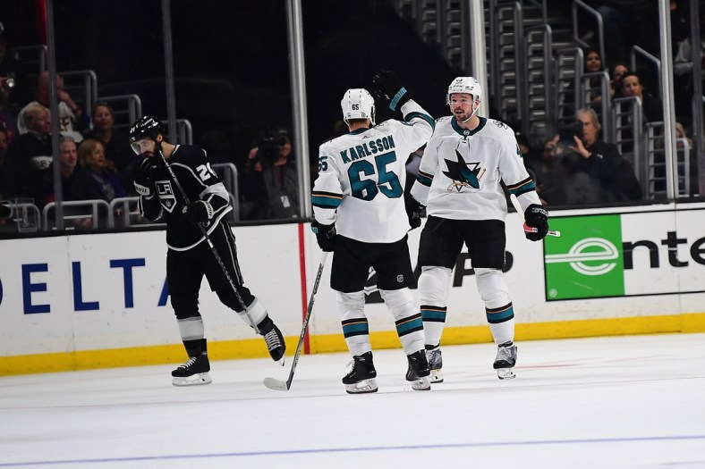 Mar 10, 2022; Los Angeles, California, USA; San Jose Sharks center Tomas Hertl (48) celebrates with defenseman Erik Karlsson (65) his goal scored against the Los Angeles Kings in overtime at Crypto.com Arena. Mandatory Credit: Gary A. Vasquez-USA TODAY Sports