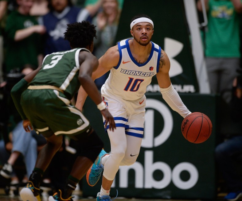 Mar 5, 2022; Fort Collins, Colorado, USA;  Boise State Broncos guard Marcus Shaver Jr. (10) dribbles the ball up court as Colorado State Rams guard Kendle Moore (3) defends during the first half at Moby Arena. Mandatory Credit: John Leyba-USA TODAY Sports
