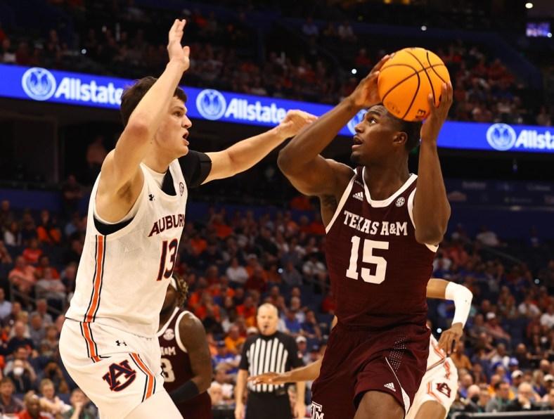 Mar 11, 2022; Tampa, FL, USA; Texas A&M Aggies forward Henry Coleman III (15) drives to the basket as Auburn Tigers forward Walker Kessler (13) defends during the first half at Amalie Arena. Mandatory Credit: Kim Klement-USA TODAY Sports