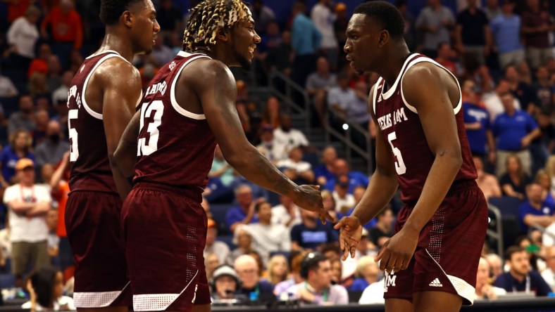 Mar 11, 2022; Tampa, FL, USA; Texas A&M Aggies guard Tyrece Radford (23) is congratulated by guard Hassan Diarra (5) and forward Henry Coleman III (15) during the first half at Amalie Arena. Mandatory Credit: Kim Klement-USA TODAY Sports