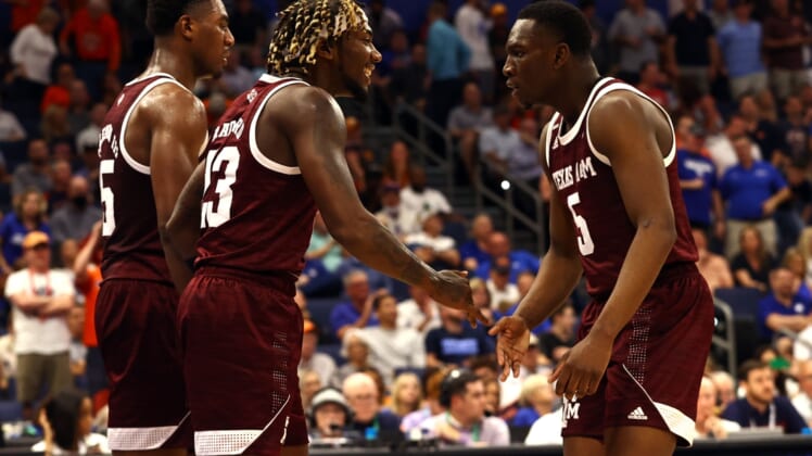 Mar 11, 2022; Tampa, FL, USA; Texas A&M Aggies guard Tyrece Radford (23) is congratulated by guard Hassan Diarra (5) and forward Henry Coleman III (15) during the first half at Amalie Arena. Mandatory Credit: Kim Klement-USA TODAY Sports