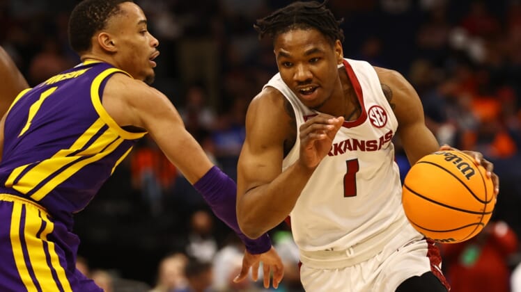 Mar 11, 2022; Tampa, FL, USA; Arkansas Razorbacks drives to the basket as LSU Tigers guard Xavier Pinson (1) defends during the first half at Amalie Arena. Mandatory Credit: Kim Klement-USA TODAY Sports