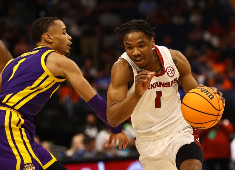 Mar 11, 2022; Tampa, FL, USA; Arkansas Razorbacks drives to the basket as LSU Tigers guard Xavier Pinson (1) defends during the first half at Amalie Arena. Mandatory Credit: Kim Klement-USA TODAY Sports