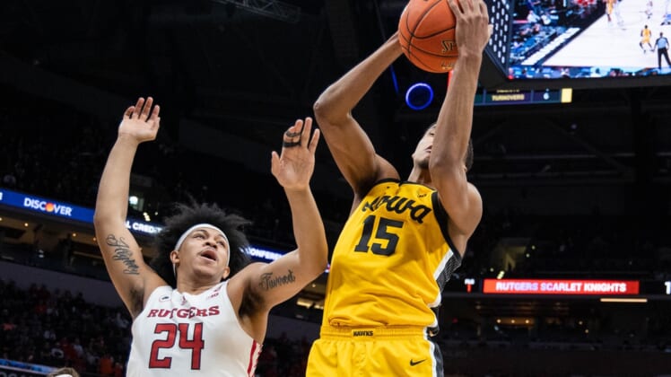 Mar 11, 2022; Indianapolis, IN, USA; Iowa Hawkeyes forward Keegan Murray (15) rebounds the ball over Rutgers Scarlet Knights forward Ron Harper Jr. (24) in the first half at Gainbridge Fieldhouse. Mandatory Credit: Trevor Ruszkowski-USA TODAY Sports