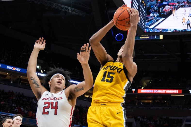 Mar 11, 2022; Indianapolis, IN, USA; Iowa Hawkeyes forward Keegan Murray (15) rebounds the ball over Rutgers Scarlet Knights forward Ron Harper Jr. (24) in the first half at Gainbridge Fieldhouse. Mandatory Credit: Trevor Ruszkowski-USA TODAY Sports