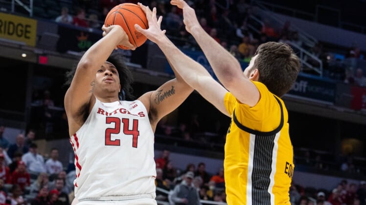 Mar 11, 2022; Indianapolis, IN, USA; Rutgers Scarlet Knights forward Ron Harper Jr. (24) shoots the ball while Iowa Hawkeyes guard Connor McCaffery (30) defends in the second half at Gainbridge Fieldhouse. Mandatory Credit: Trevor Ruszkowski-USA TODAY Sports