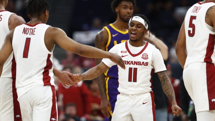 Mar 11, 2022; Tampa, FL, USA; Arkansas Razorbacks guard Chris Lykes (11) and teammates high five against the LSU Tigers during the second half at Amalie Arena. Mandatory Credit: Kim Klement-USA TODAY Sports