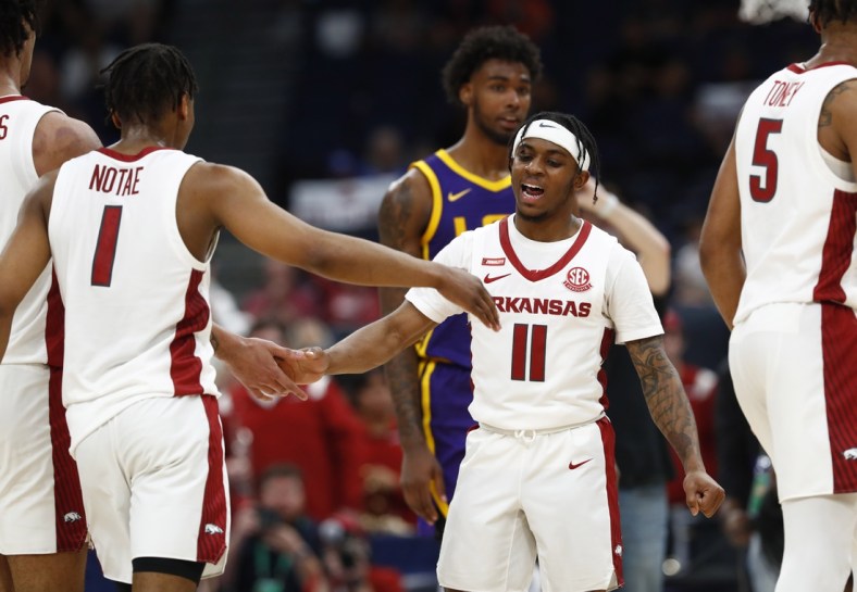 Mar 11, 2022; Tampa, FL, USA; Arkansas Razorbacks guard Chris Lykes (11) and teammates high five against the LSU Tigers during the second half at Amalie Arena. Mandatory Credit: Kim Klement-USA TODAY Sports
