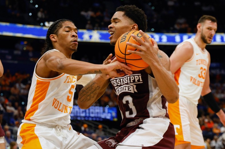 Mar 11, 2022; Tampa, FL, USA; Tennessee Volunteers guard Zakai Zeigler (5) fouls Mississippi State Bulldogs guard Shakeel Moore (3) in the first half at Amelie Arena. Mandatory Credit: Nathan Ray Seebeck-USA TODAY Sports