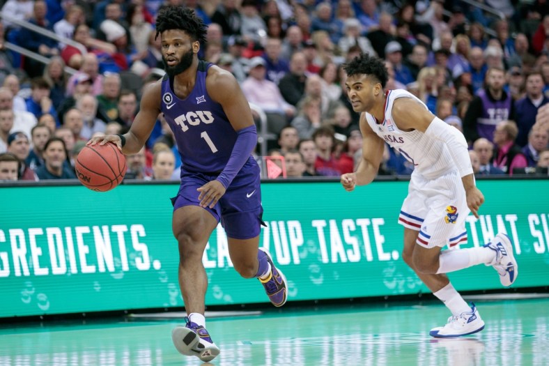 Mar 11, 2022; Kansas City, MO, USA; TCU Horned Frogs guard Mike Miles (1) brings the ball up court past Kansas Jayhawks guard Remy Martin (11) during the first half at T-Mobile Center. Mandatory Credit: William Purnell-USA TODAY Sports