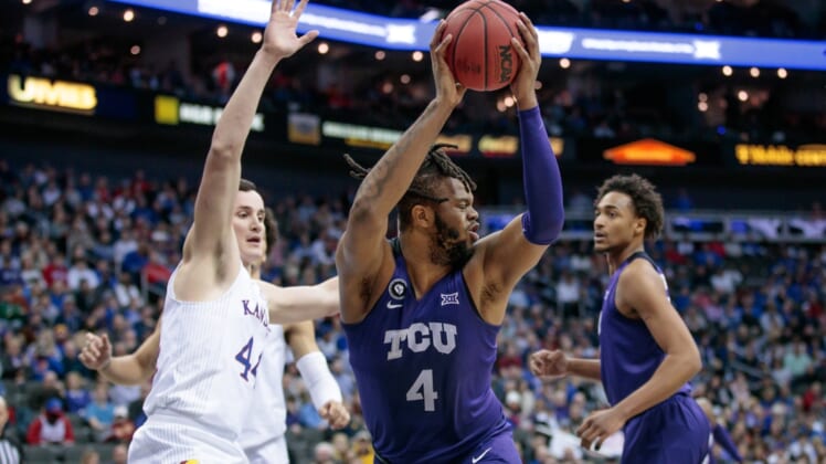 Mar 11, 2022; Kansas City, MO, USA; TCU Horned Frogs center Eddie Lampkin (4) grabs a rebound during the first half against the Kansas Jayhawks at T-Mobile Center. Mandatory Credit: William Purnell-USA TODAY Sports