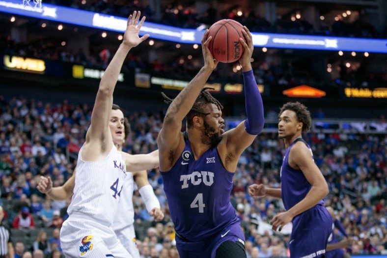 Mar 11, 2022; Kansas City, MO, USA; TCU Horned Frogs center Eddie Lampkin (4) grabs a rebound during the first half against the Kansas Jayhawks at T-Mobile Center. Mandatory Credit: William Purnell-USA TODAY Sports
