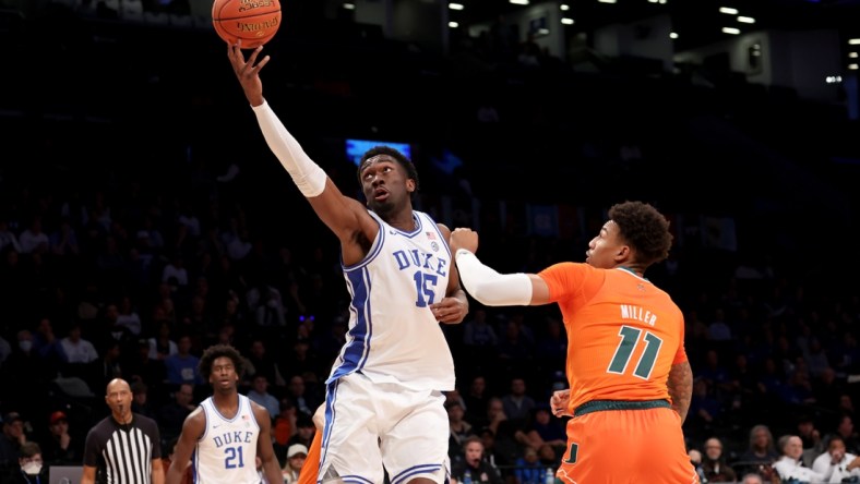 Mar 11, 2022; Brooklyn, NY, USA; Duke Blue Devils center Mark Williams (15) drives to the basket against Miami Hurricanes guard Jordan Miller (11) during the first half of the ACC Tournament semifinal game at Barclays Center. Mandatory Credit: Brad Penner-USA TODAY Sports