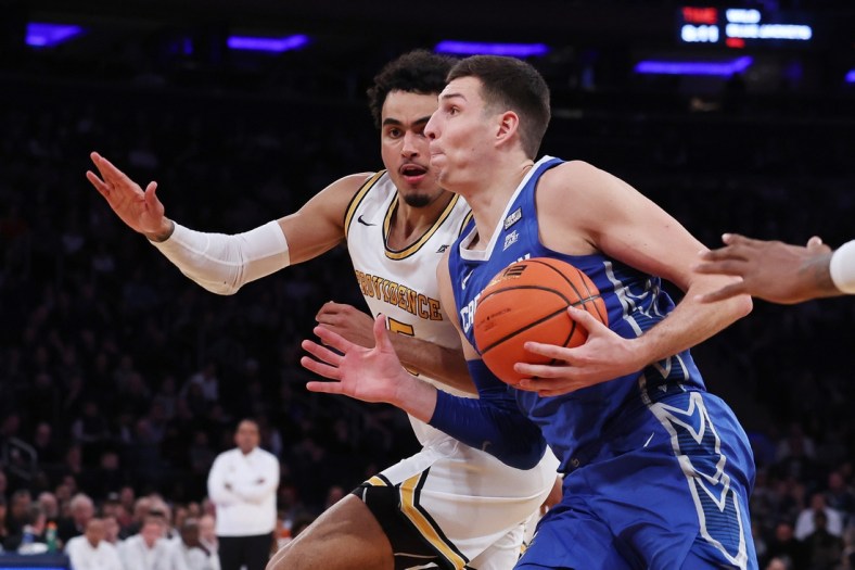 Mar 11, 2022; New York, NY, USA; Creighton Bluejays forward Ryan Hawkins (44) drives to the basket as Providence Friars forward Justin Minaya (15) defends during the second half at Madison Square Garden. Mandatory Credit: Vincent Carchietta-USA TODAY Sports