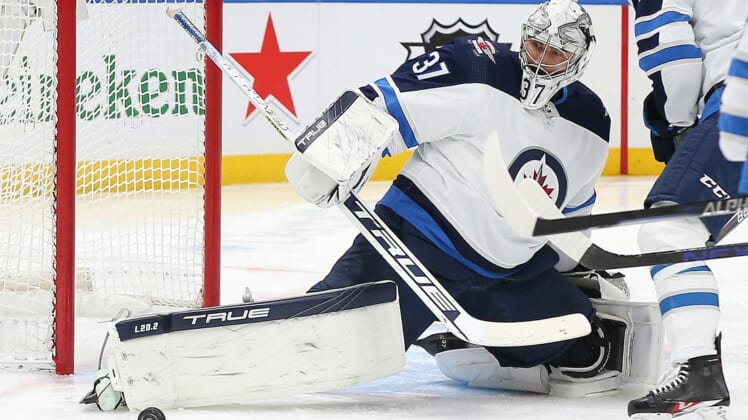 Mar 11, 2022; Elmont, New York, USA; Winnipeg Jets goaltender Connor Hellebuyck (37) makes a save against the New York Islanders during the second period at UBS Arena. Mandatory Credit: Andy Marlin-USA TODAY Sports