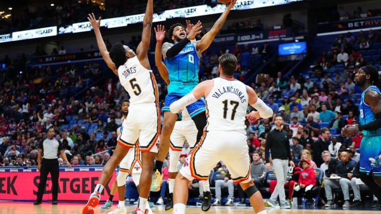 Mar 11, 2022; New Orleans, Louisiana, USA; Charlotte Hornets forward Miles Bridges (0) shoots the ball against New Orleans Pelicans forward Herbert Jones (5) during the second quarter at Smoothie King Center. Mandatory Credit: Andrew Wevers-USA TODAY Sports