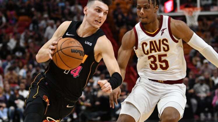 Mar 11, 2022; Miami, Florida, USA; Cleveland Cavaliers forward Isaac Okoro (35) defends Miami Heat guard Tyler Herro (14) during the first half at FTX Arena. Mandatory Credit: Jim Rassol-USA TODAY Sports