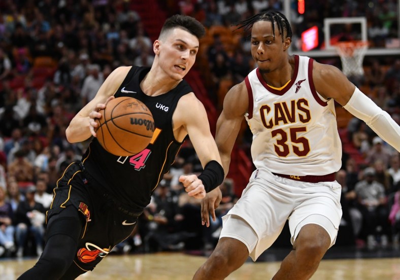 Mar 11, 2022; Miami, Florida, USA; Cleveland Cavaliers forward Isaac Okoro (35) defends Miami Heat guard Tyler Herro (14) during the first half at FTX Arena. Mandatory Credit: Jim Rassol-USA TODAY Sports