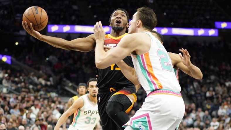 Mar 11, 2022; San Antonio, Texas, USA; Utah Jazz guard Donovan Mitchell drives to the basket while defended by shoots over San Antonio Spurs forward Zach Collins (23) during the first half at AT&T Center. Mandatory Credit: Scott Wachter-USA TODAY Sports