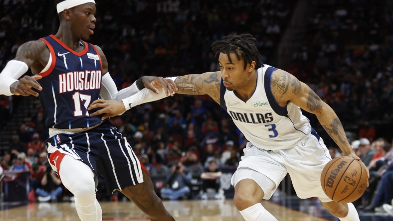 Mar 11, 2022; Houston, Texas, USA; Dallas Mavericks guard Trey Burke (3) controls the ball as Houston Rockets guard Dennis Schroder (17) defends during the third quarter at Toyota Center. Mandatory Credit: Troy Taormina-USA TODAY Sports