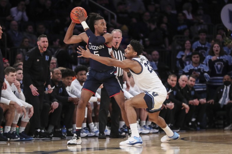 Mar 11, 2022; New York, NY, USA;  Connecticut Huskies forward Isaiah Whaley (5) is guarded by Villanova Wildcats forward Jermaine Samuels (23) in the first half at the Big East Tournament at Madison Square Garden. Mandatory Credit: Wendell Cruz-USA TODAY Sports