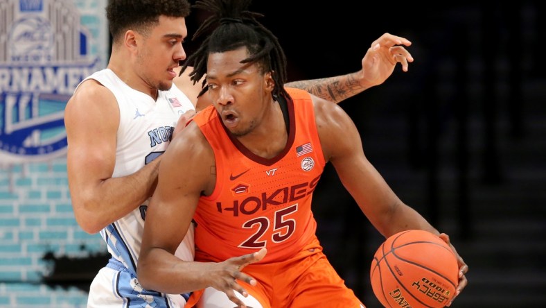 Mar 11, 2022; Brooklyn, NY, USA; Virginia Tech Hokies forward Justyn Mutts (25) controls the ball against North Carolina Tar Heels forward Justin McKoy (22) during the first half of the ACC Tournament semifinal game at Barclays Center. Mandatory Credit: Brad Penner-USA TODAY Sports