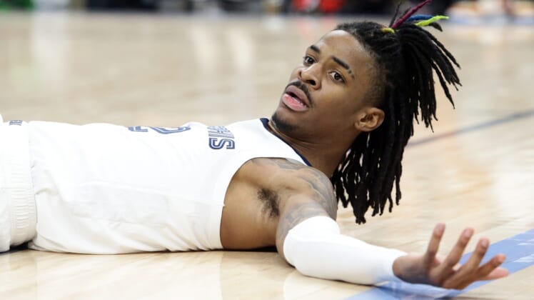 Mar 11, 2022; Memphis, Tennessee, USA; Memphis Grizzlies guard Ja Morant (12) lays on the floor after a foul during the second half against the New York Knicks at FedExForum. Mandatory Credit: Petre Thomas-USA TODAY Sports