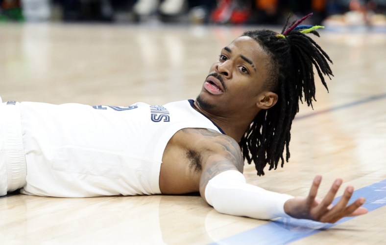Mar 11, 2022; Memphis, Tennessee, USA; Memphis Grizzlies guard Ja Morant (12) lays on the floor after a foul during the second half against the New York Knicks at FedExForum. Mandatory Credit: Petre Thomas-USA TODAY Sports