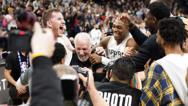 Mar 11, 2022; San Antonio, Texas, USA; San Antonio Spurs head coach Gregg Popovich is congratulated by players after becoming the winningest coach in NBA history after the game against the Utah Jazz at AT&T Center. Mandatory Credit: Scott Wachter-USA TODAY Sports