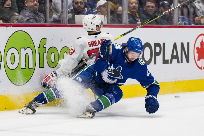 Mar 11, 2022; Vancouver, British Columbia, CAN; Vancouver Canucks defenseman Quinn Hughes (43) collides with Washington Capitals forward Conor Sheary (73) in the second period at Rogers Arena. Mandatory Credit: Bob Frid-USA TODAY Sports