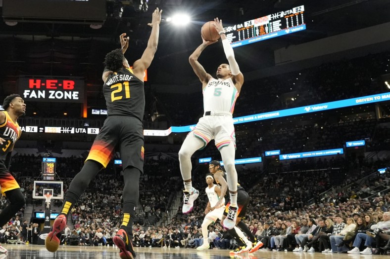 Mar 11, 2022; San Antonio, Texas, USA; San Antonio Spurs guard Dejounte Murray (5) shoots over Utah Jazz center Hassan Whiteside (21) during the second half at AT&T Center. Mandatory Credit: Scott Wachter-USA TODAY Sports