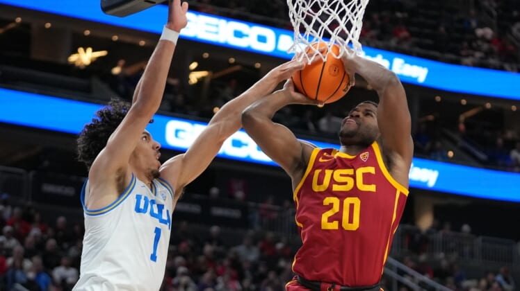Mar 11, 2022; Las Vegas, NV, USA; USC Trojans guard Ethan Anderson (20) shoots against UCLA Bruins guard Jules Bernard (1) during the first half at T-Mobile Arena. Mandatory Credit: Stephen R. Sylvanie-USA TODAY Sports