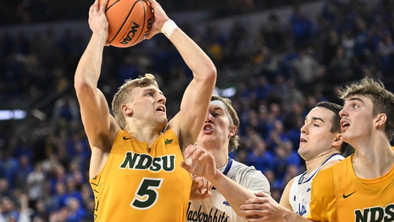 Mar 8, 2022; Sioux Falls, SD, USA;  North Dakota State Bison guard Sam Griesel (5) scores against South Dakota State Jackrabbits guard Baylor Scheierman (3) in the second half at Denny Sanford Premier Center. Mandatory Credit: Steven Branscombe-USA TODAY Sports